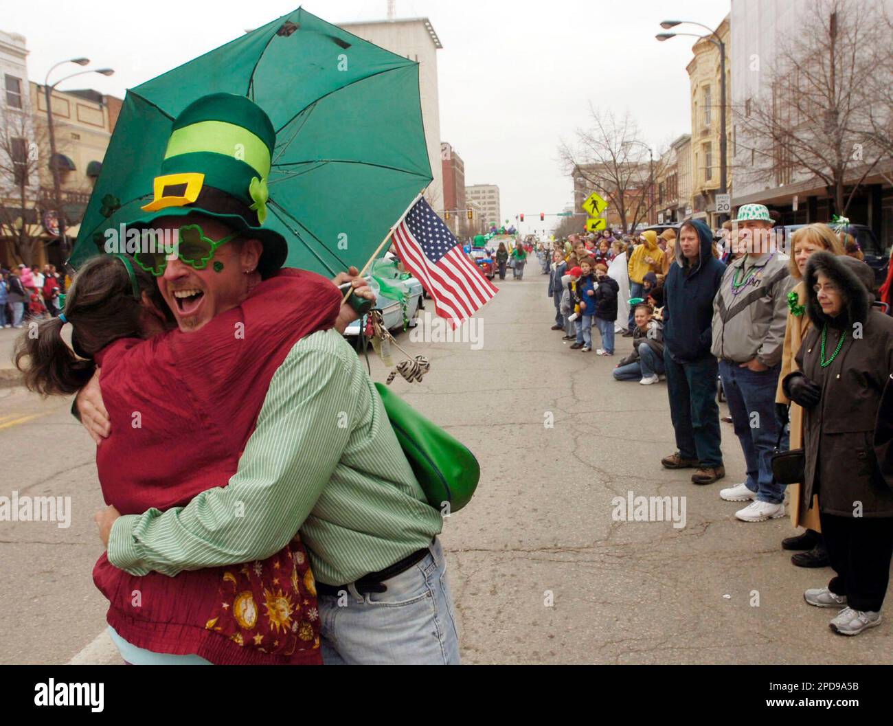Darren Wade, of Topeka, Kan., hugs St. Patrick's Day Parade participant