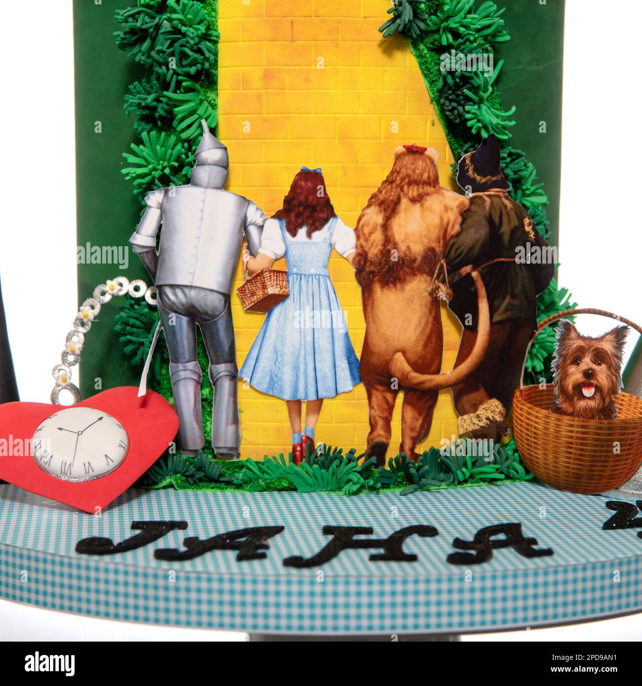 Many character in wizard of OZ. Magical fantasy team on cake made of craft paper. Emerald city gate and rainbow. Design cake of the theme is inspired Stock Photo