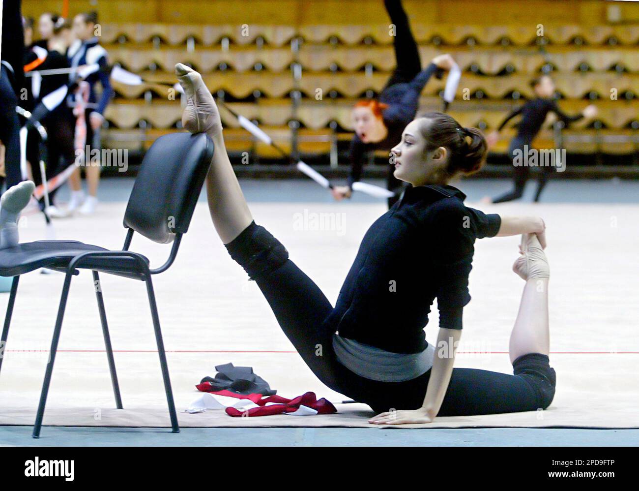 Ukrainian Anna Bessonova, World Champion in rhythmic gymnastics, stretches herself during a warm up session in the Ukrainian capital Kiev's Sports Palace on Thursday, March 16, 2006, on the eve of the Deriugina Cup Grand Prix international competition. Some 25 countries are expected to compete during the three-day tournament. (AP Photo/Efrem Lukatsky) Stock Photo