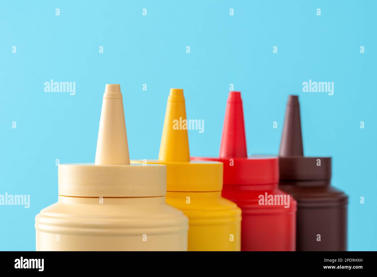 Plastic bottles of mayo, ketchup, mustard, and barbeque sauce. Various