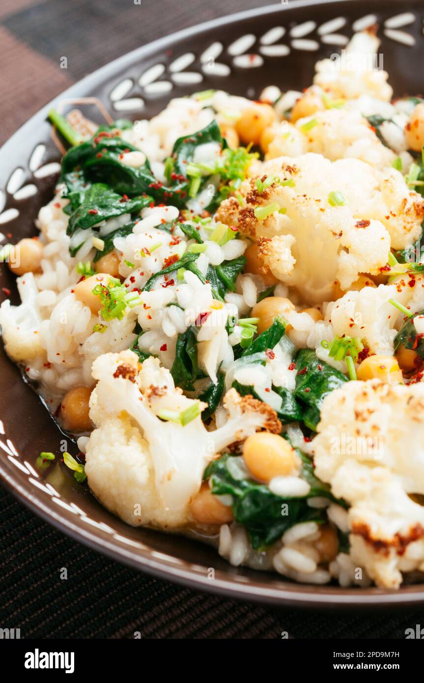 Roasted Cauliflower Risotto with Spinach and Chickpeas Stock Photo