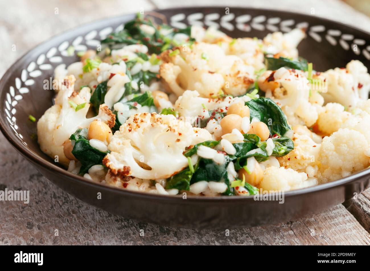 Roasted Cauliflower Risotto with Spinach and Chickpeas Stock Photo