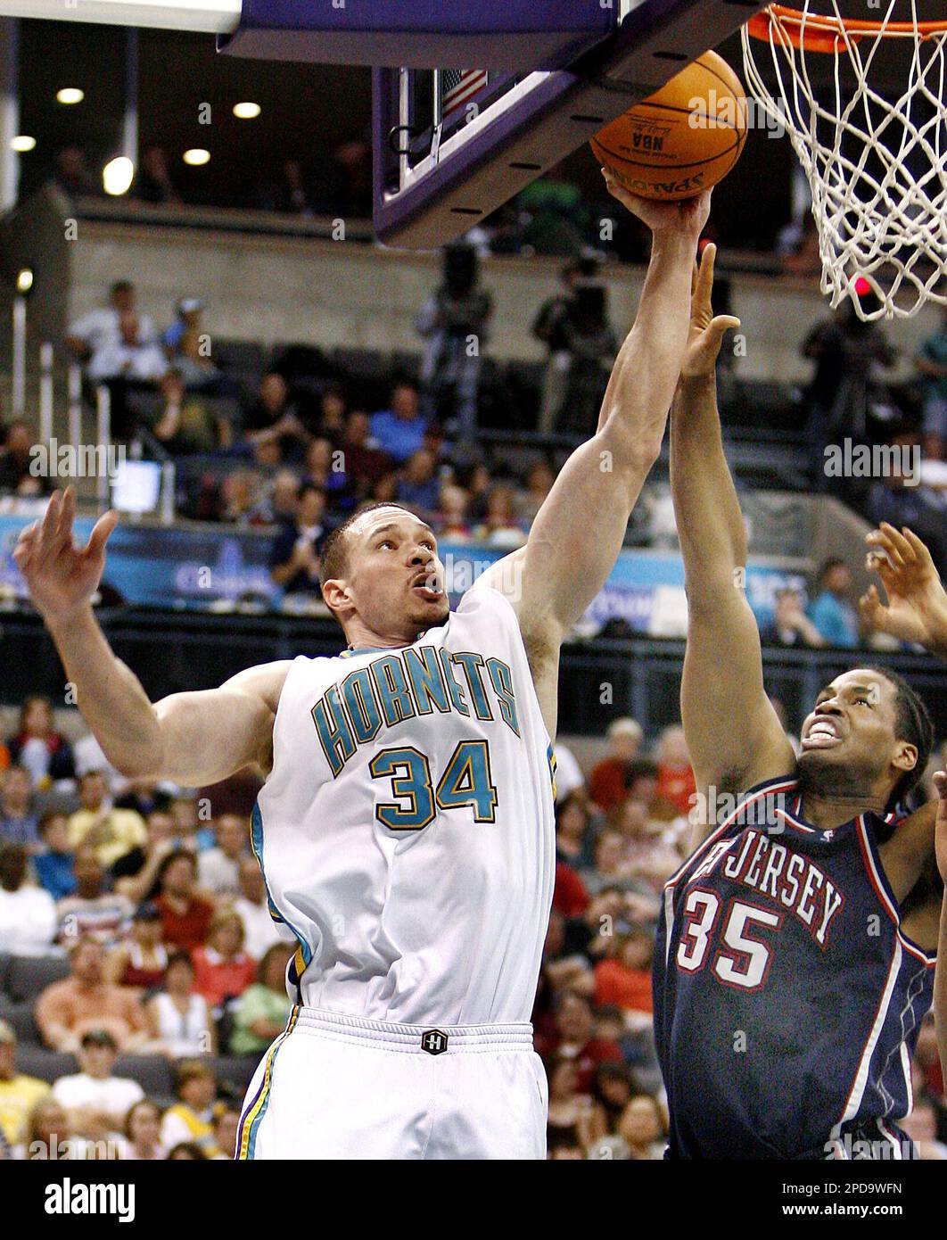 New Orleans Hornets center Aaron Williams (34) shoots the ball over New  Jersey Nets forward Jason Collins (35) in the second half of an NBA  basketball game Sunday, March. 12, 2006, in