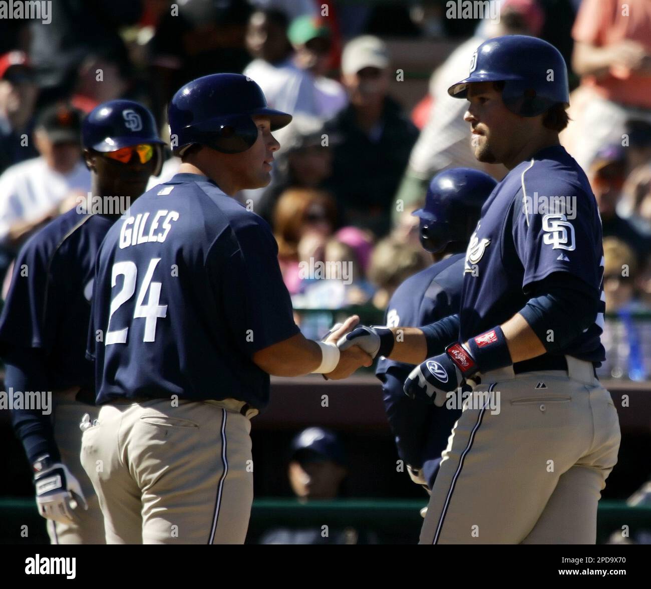 San Diego Padres' Mike Piazza, right, is greeted by teammate Brian Giles,  left, after hitting a grand slam off San Francisco Giants' pitcher Armando  Benitez during the fifth inning of their spring