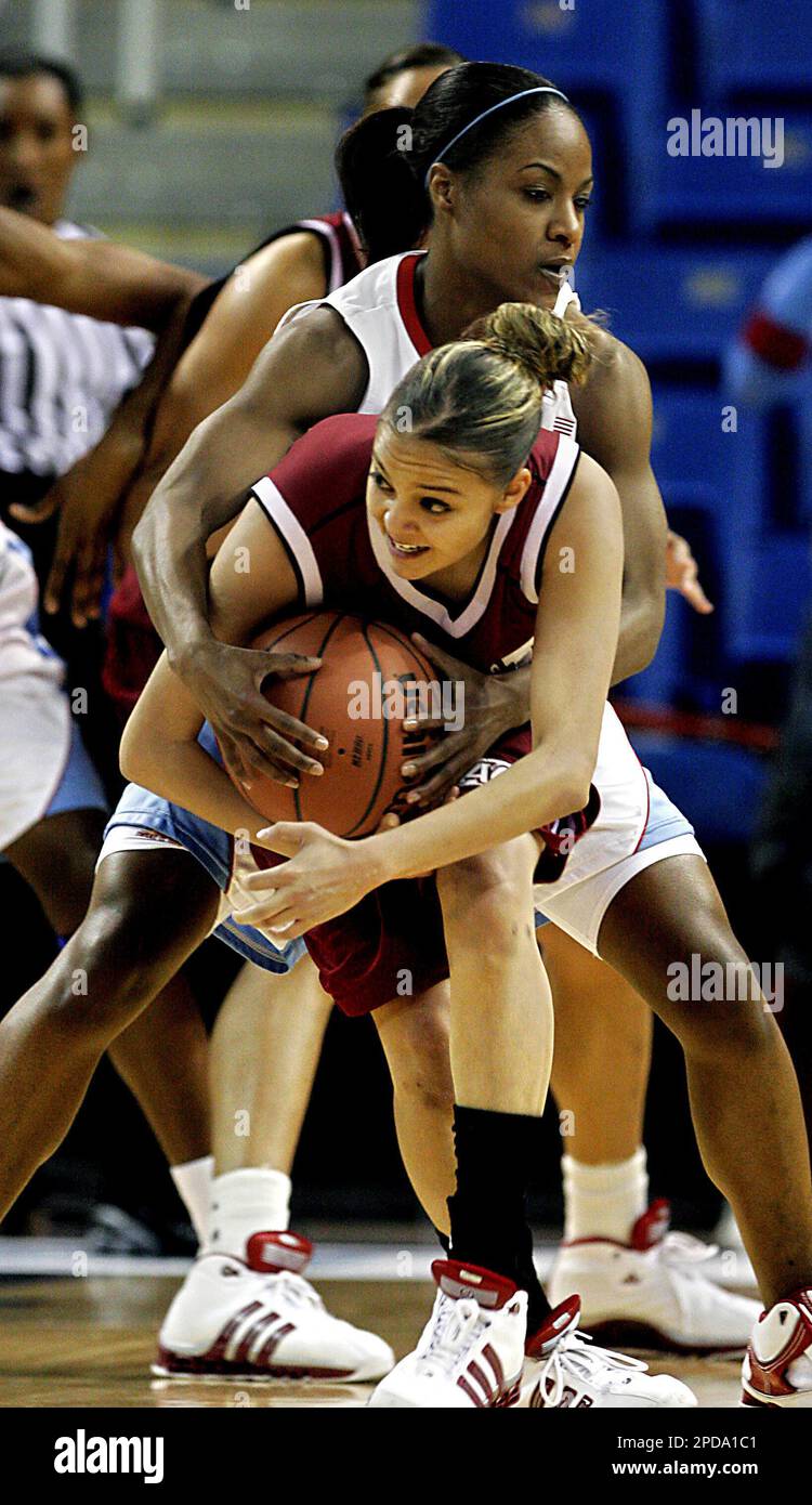New Mexico State guard Monique Bribiescas, forground, is fouled from behind  by Louisiana Tech guard Tasha Williams during the first half of the  championship game of the women's Western Athletic Conference tournament