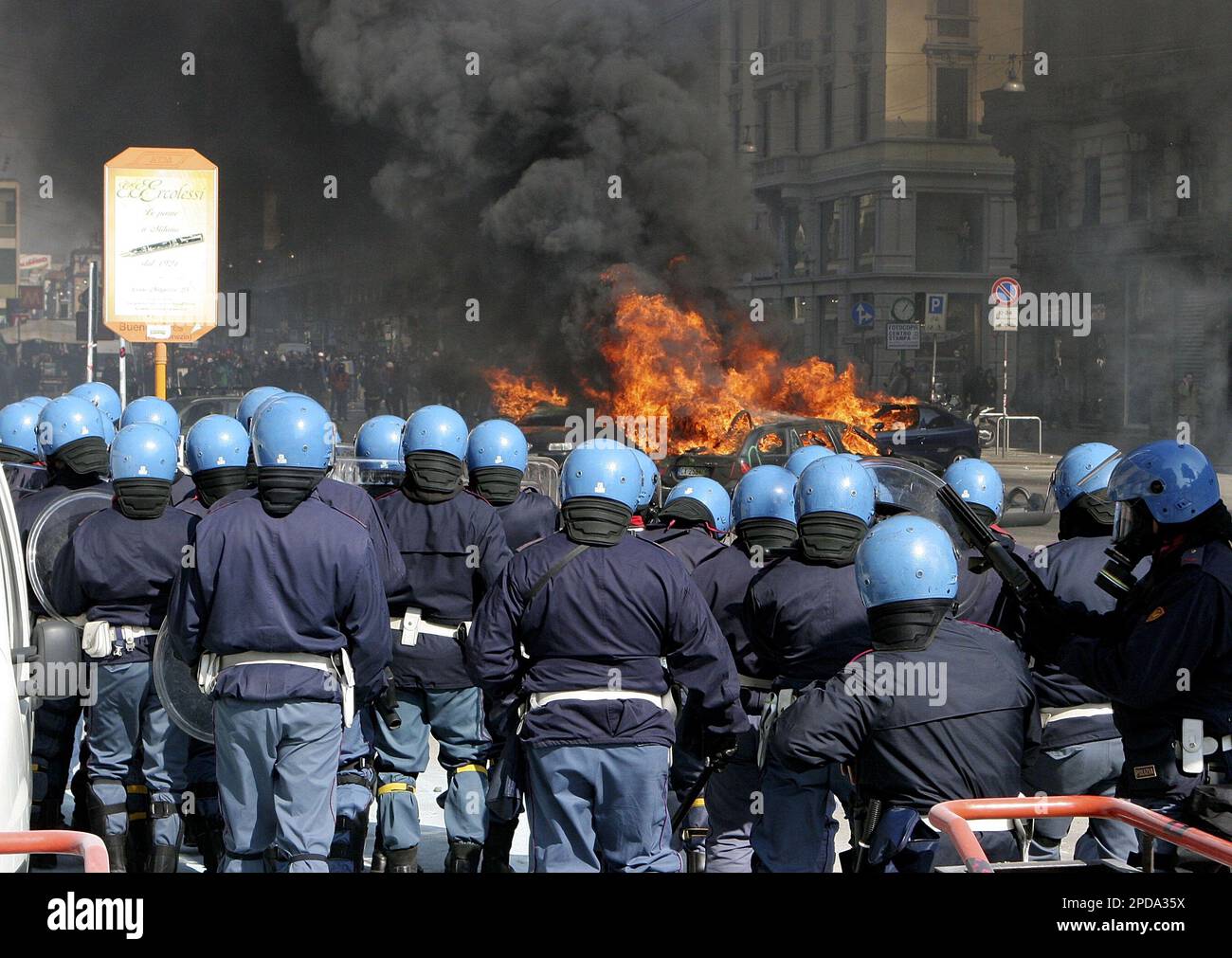 Italian police face demonstrators during clashes between police and  demonstrators in downtown Milan, Italy, Saturday, March 11, 2006. Police  clashed in Milan with youths from far-left social clubs who torched cars and