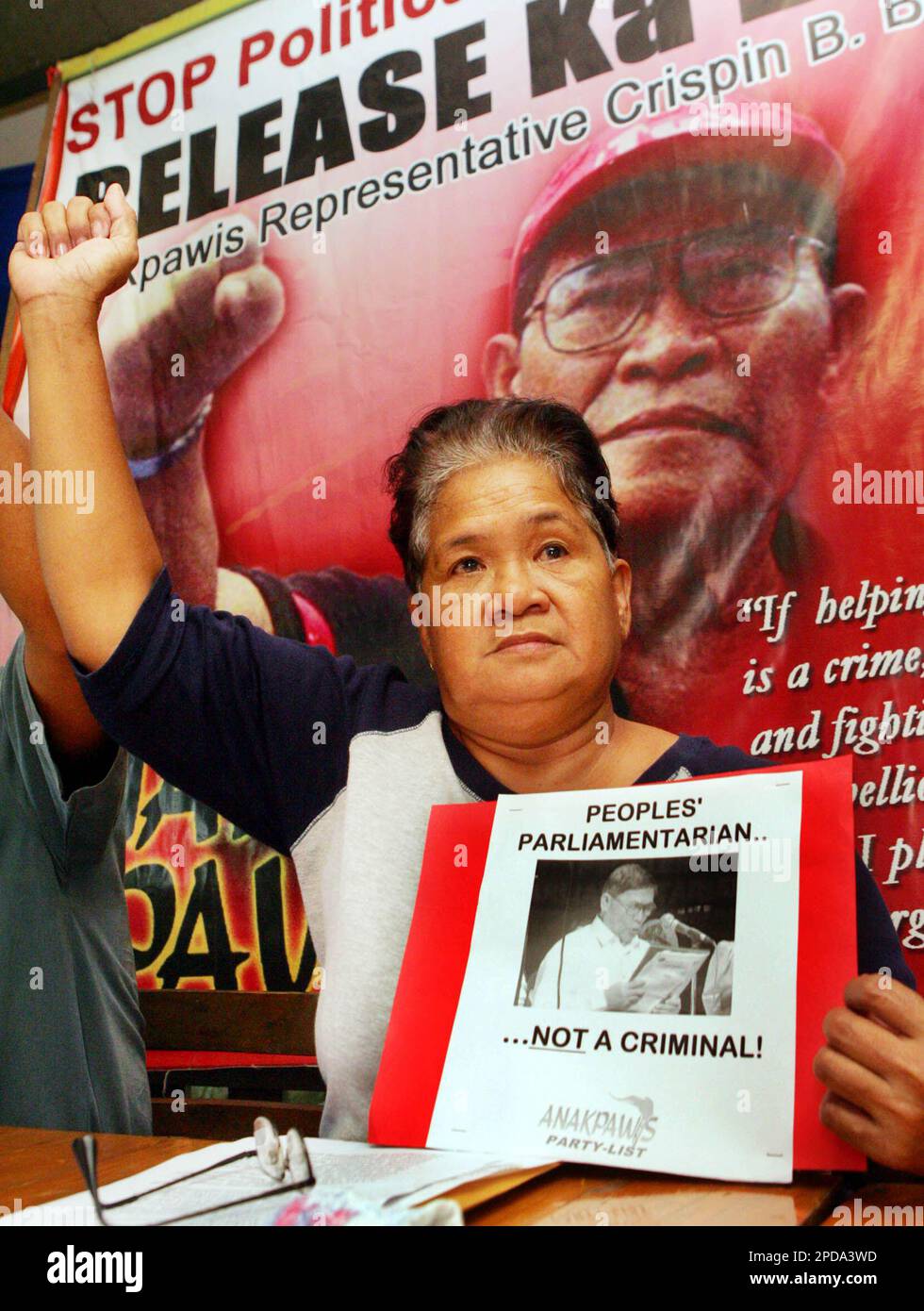 Rosario Beltran, wife of detained leftist Rep. Crispin Beltran, raises a clenched fist during a press conference Saturday in suburban Quezon City, north of Manila. Rosario Beltran called on the police authorities to release her husband who was arrested during the proclamation of the state of national emergency by President Gloria Macapagal Arroyo to quash coup attempts against her government. (AP Photo/Pat Roque) Stock Photo