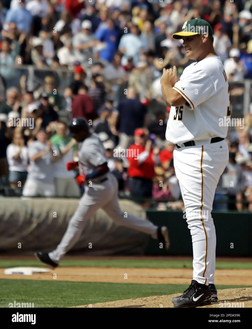 Team USA's Derek Jeter (rt) congratulates teammate Ken Griffey, Jr. as  Griffey crosses homeplate on a homerun in the second inning against Team  South Africa in the World Baseball Classic game in