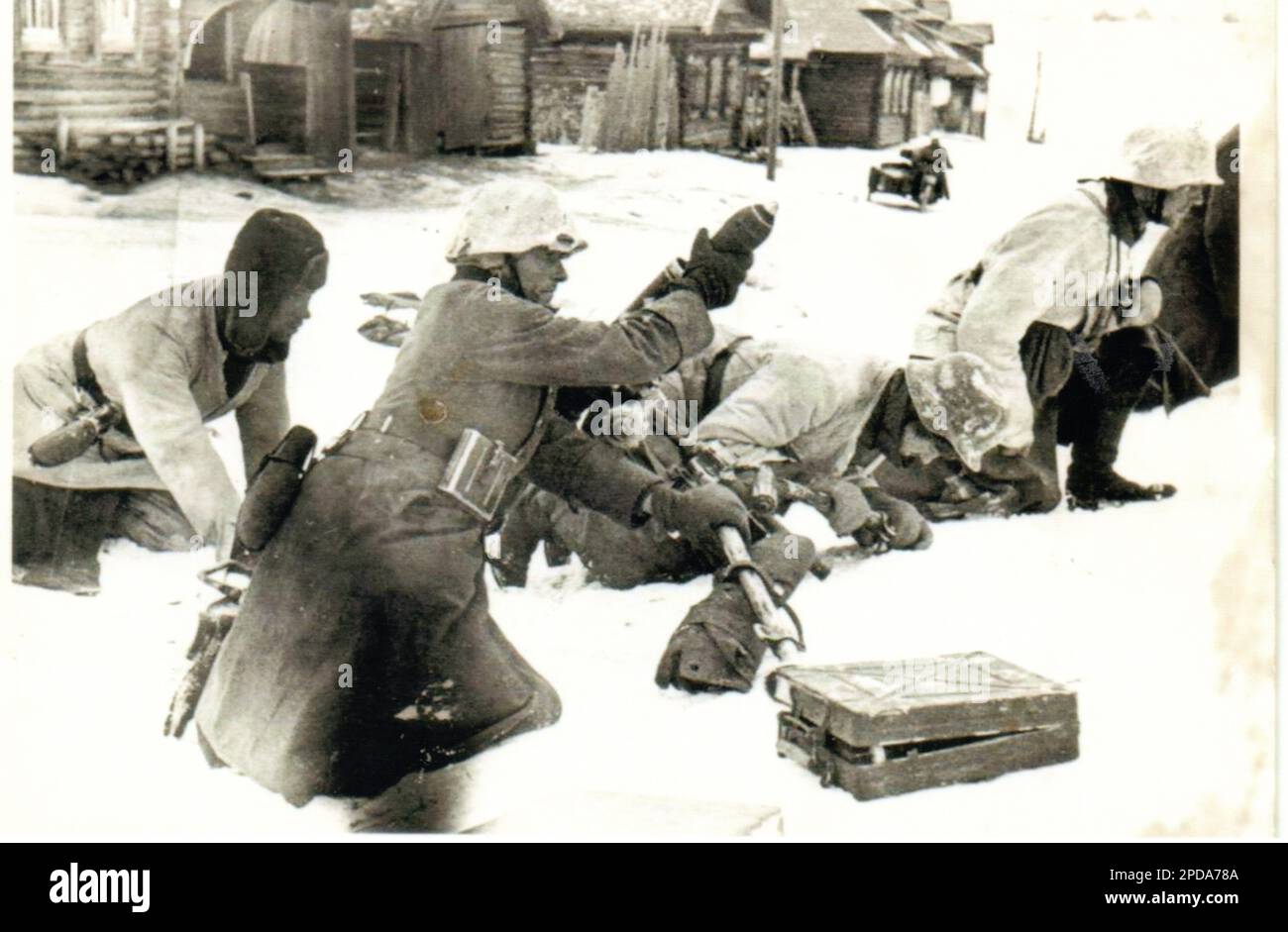 World War Two B&W photo German Soldiers fire a Mortar on the Russian Front during the Winter Months of 1941/42 . These soldiers are poorly attired with a variety Winter wear Stock Photo