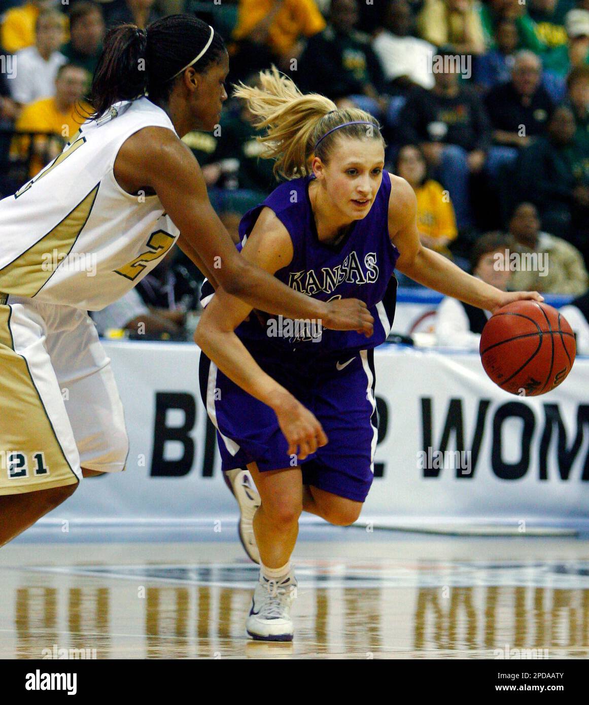 Kansas State guard Claire Coggins, right, drives around Baylor guard Chameka Scott in the second half of their Big 12 Women's Championship tournament basketball game, Wednesday, March 8, 2006, in Dallas. Baylor won 79-74 in overtime. (AP Photo/Matt Slocum) Stock Photo