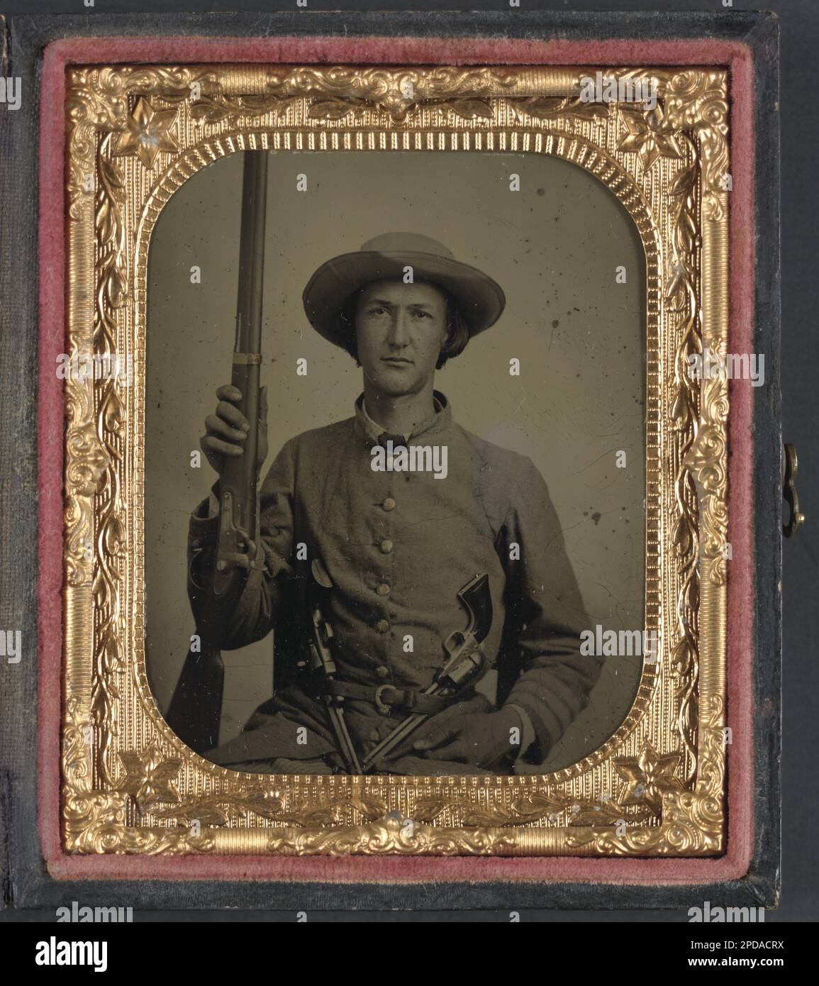 Unidentified soldier in Confederate infantry uniform with model 1842 musket and two Colt revolvers. Liljenquist Family Collection of Civil War Photographs , FAmbrotype/Tintype photograph filing series , Published in: Turner, William A. Even more Confederate faces. Gaithersburg, Md.: Olde Soldier Books, Inc,1993, p. 187, Published in: Echoes of glory : Arms and equipment of the Union. Alexandria, Va.: Time-Life Books, 2000, p. 28, Published in: Civil War pistols : a survey of the handguns of the American Civil War / by John D. McAulay. Lincoln, R.I, USA : A. Mowbray, c1992, p. 49, NewsetLilj03, Stock Photo