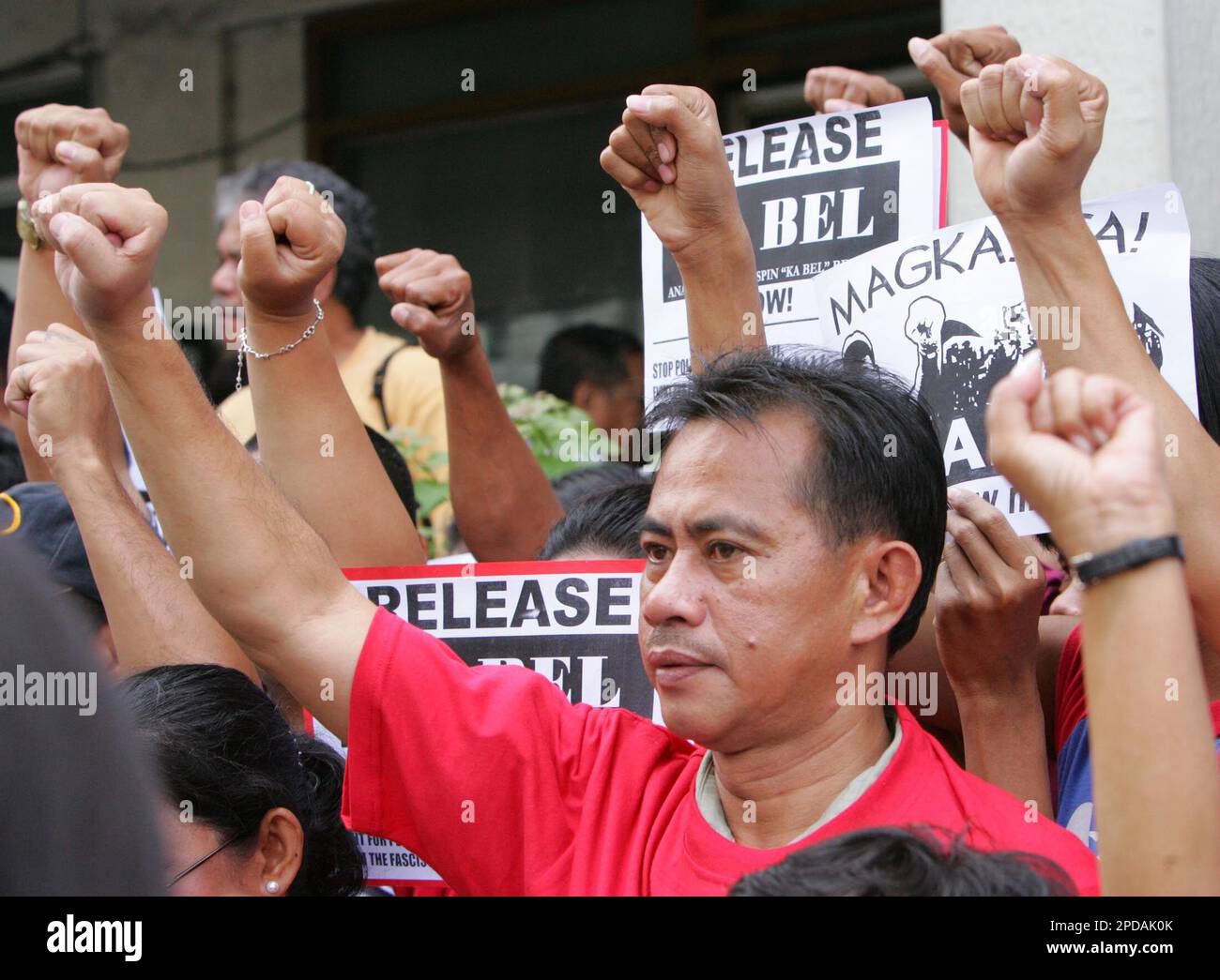 Leftist protesters raise their clenched fist as they call for the release of party-list Congressman Crispin Beltran Monday, March 6, 2006 at the trial court in Makati City south of Manila. Congressman Beltran was arrested without a warrant during the state of national democracy declared by President Gloria Macapagal Arroyo. (AP Photo/Pat Roque) Stock Photo