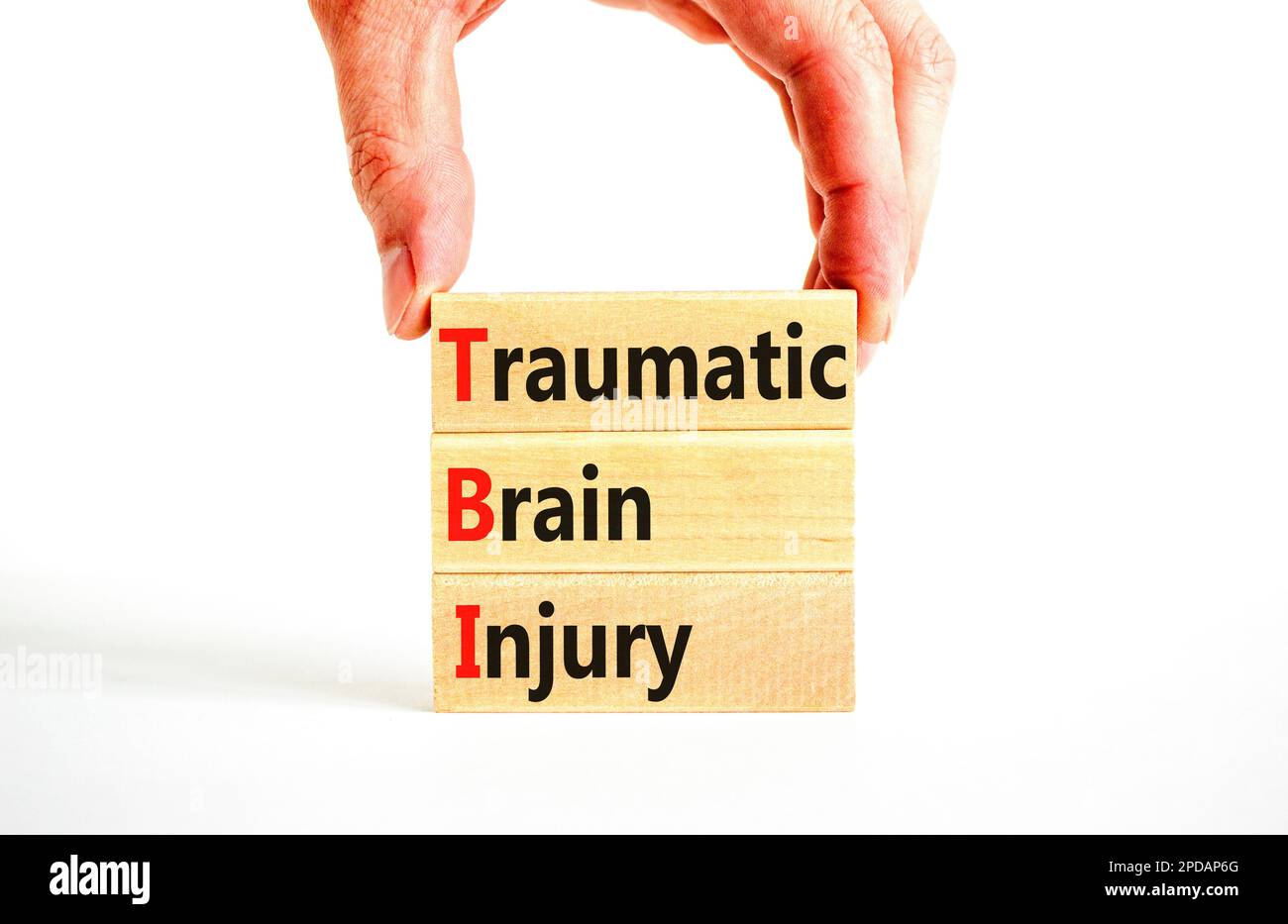 TBI traumatic brain injury symbol. Concept words TBI traumatic brain injury on wooden blocks on a beautiful white table white background. Medical and Stock Photo