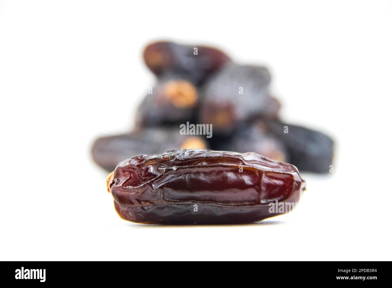 Dates isolated on white background, amber dates, Ramadan food, front view, noise effect, Noise and Pollution Effect on photos. Stock Photo