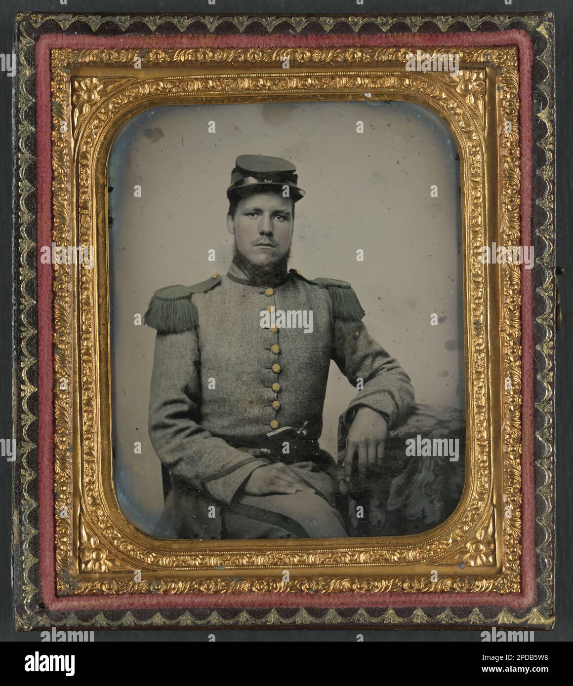 Private Joseph T. Rowland of Co. A, 41st Virginia Infantry Regiment in uniform with epaulets and kepi with pistol in belt. Liljenquist Family Collection of Civil War Photographs , FAmbrotype/Tintype photograph filing series , pp/liljconfed. Rowland, Joseph T, approximately 1839- , Confederate States of America, Army, Virginia Infantry Regiment, 41st, People, 1860-1870, Soldiers, Confederate, 1860-1870, Military uniforms, Confederate, 1860-1870, Handguns, 1860-1870, United States, History, Civil War, 1861-1865, Military personnel, Confederate. Stock Photo