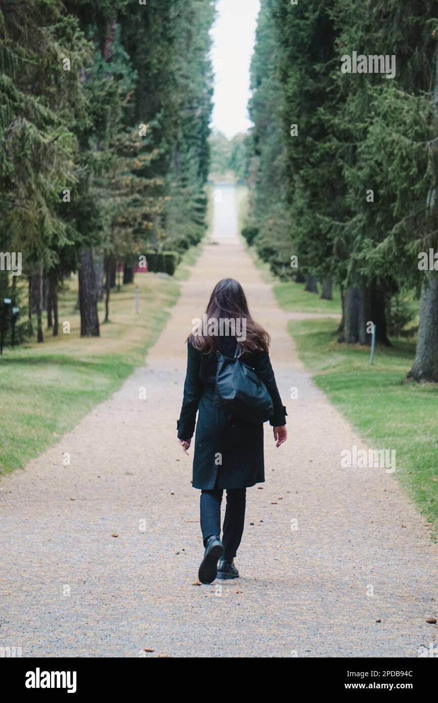 Woman coat walking rear view hi-res stock photography and images - Alamy