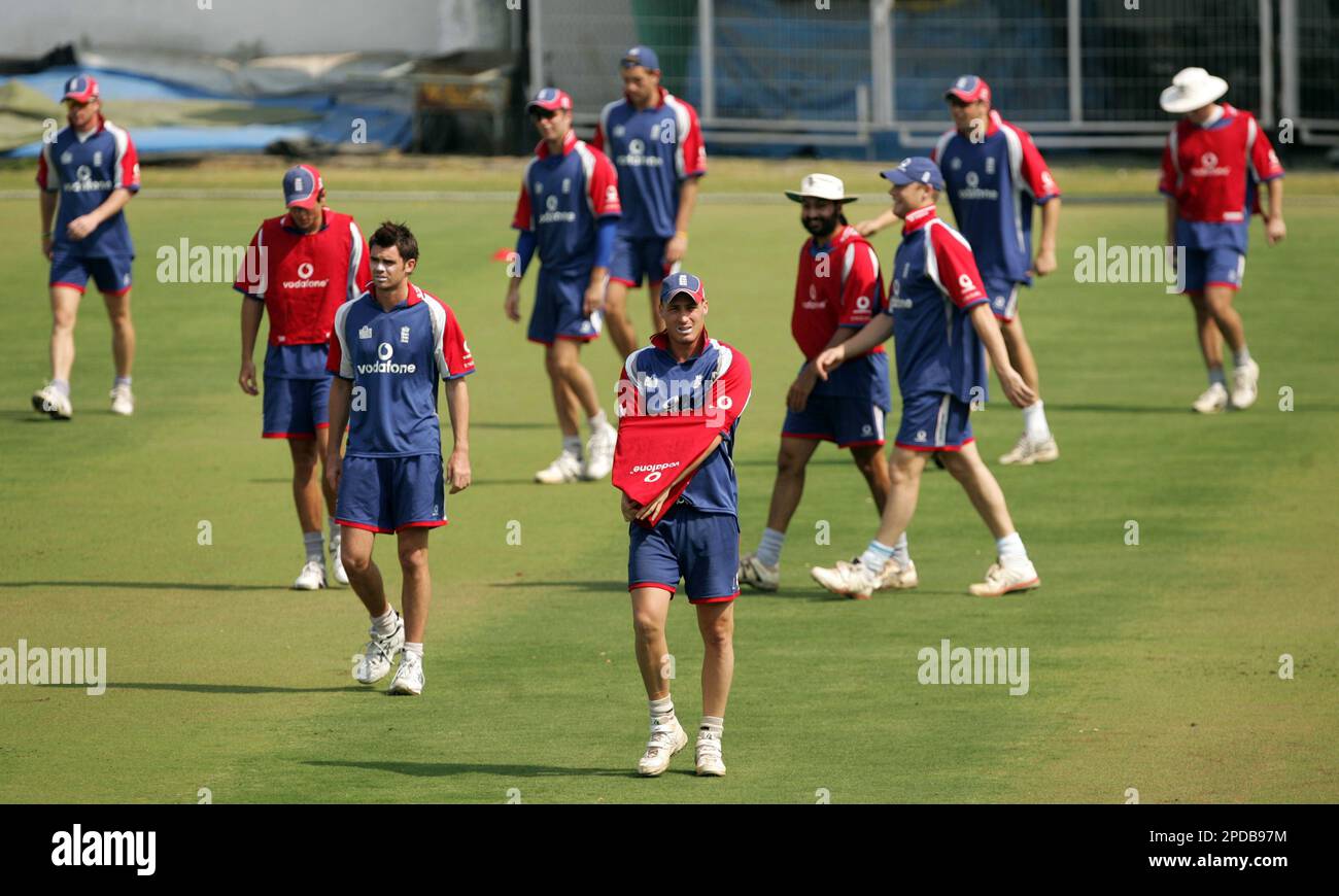 England cricket players look on during a training session, two