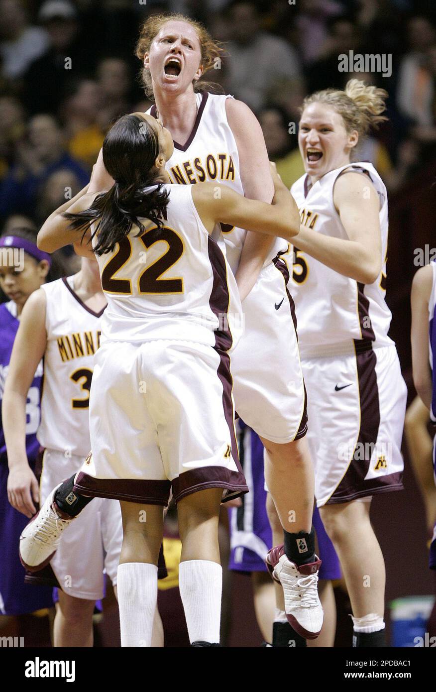 Minnesota center Christina Collison, center, leaps into the