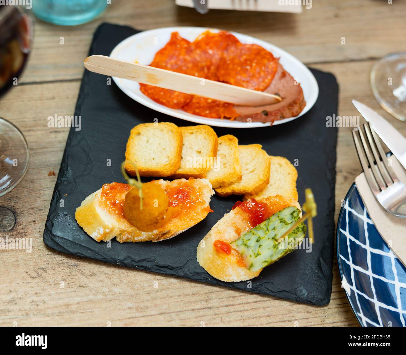 Assorted Spanish tapas with cheese and sausage Stock Photo - Alamy