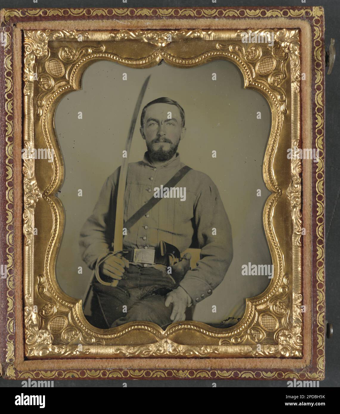 Lieutenant William Bowen Gallaher of Co. E, 1st Virginia Cavalry Regiment in uniform and Virginia state seal belt plate, with revolver and cavalry sword. Liljenquist Family Collection of Civil War Photographs , Published in: Kelbaugh, Ross J. Introduction to Civil War photography. Gettysburg, Pa.: Thomas Publications, 1991, p. 16, Published in: Driver, Robert J. 1st Virginia Cavalry. Lynchburg, Va. : H. E. Howard, 1991, p. 134, pp/liljconfed. Gallaher, William Bowen, 1840-1911, Confederate States of America, Army, People, 1860-1870, Soldiers, Confederate, 1860-1870, Military uniforms, Confeder Stock Photo