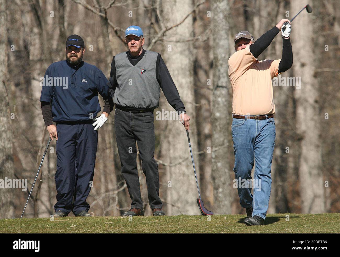 Mike Logan, right, of Burns, Tenn., watches his tee shot along with