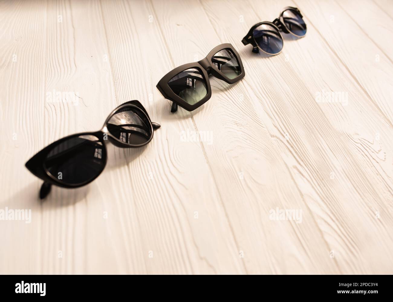 Stylish black sunglasses. Summer background mockup template text. pattern  top view above white wooden background. Summer fashion accessories for  beach Stock Photo - Alamy