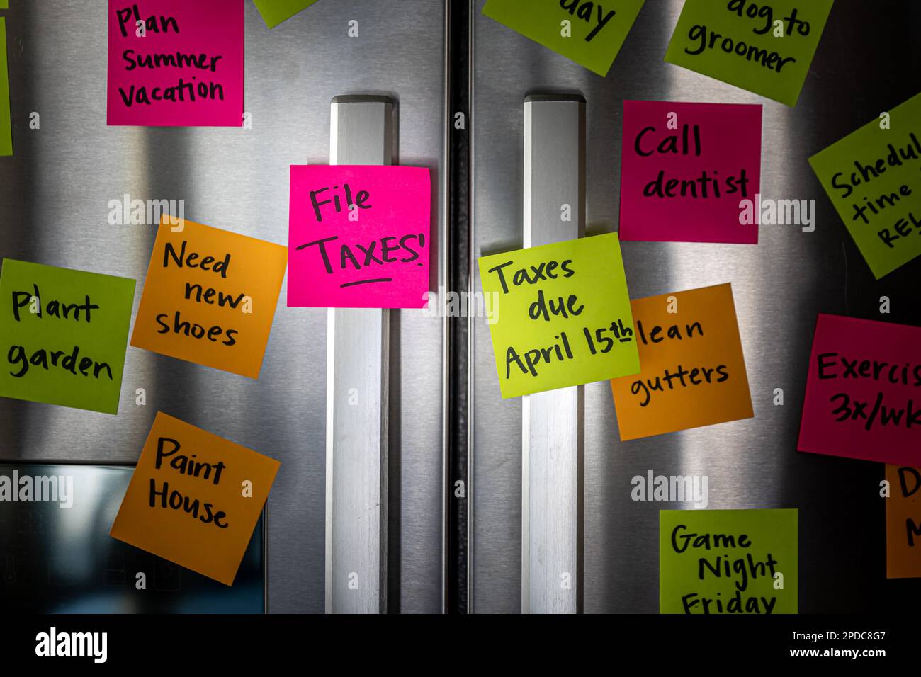 Refrigerator door with colorful memo notes reminding to file taxes on