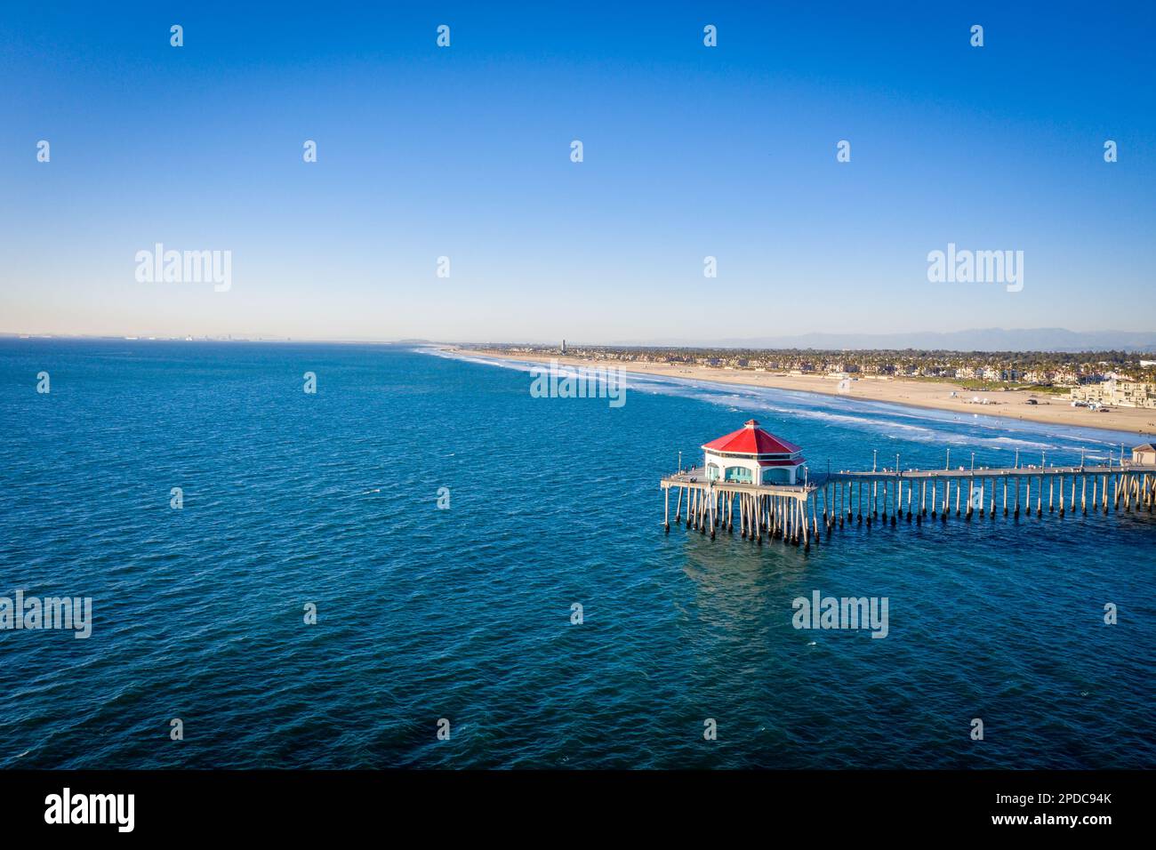 Aerial above the Pacific Ocean showing the shoreline of Huntington