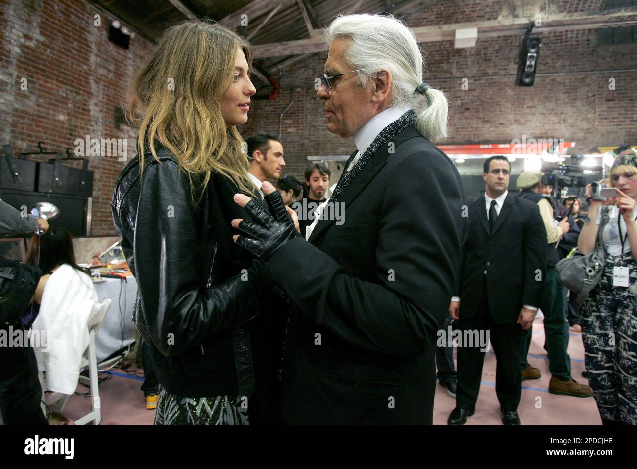 Karl Lagerfeld talks to model Daria Werbowy backstage before the  presentation of his fall 2006 collection