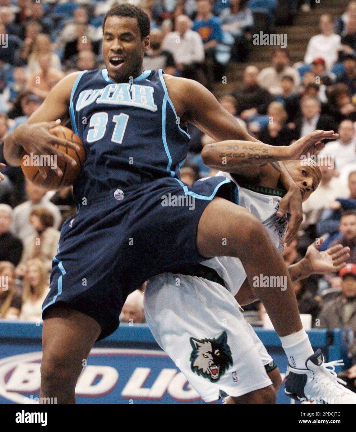 Utah Jazz's Jarron Collins (31) comes down onto Minnesota Timberwolves'  Anthony Carter, right, while pulling down a rebound during the first  quarter of an NBA basketball game Friday, Feb. 10, 2006, in