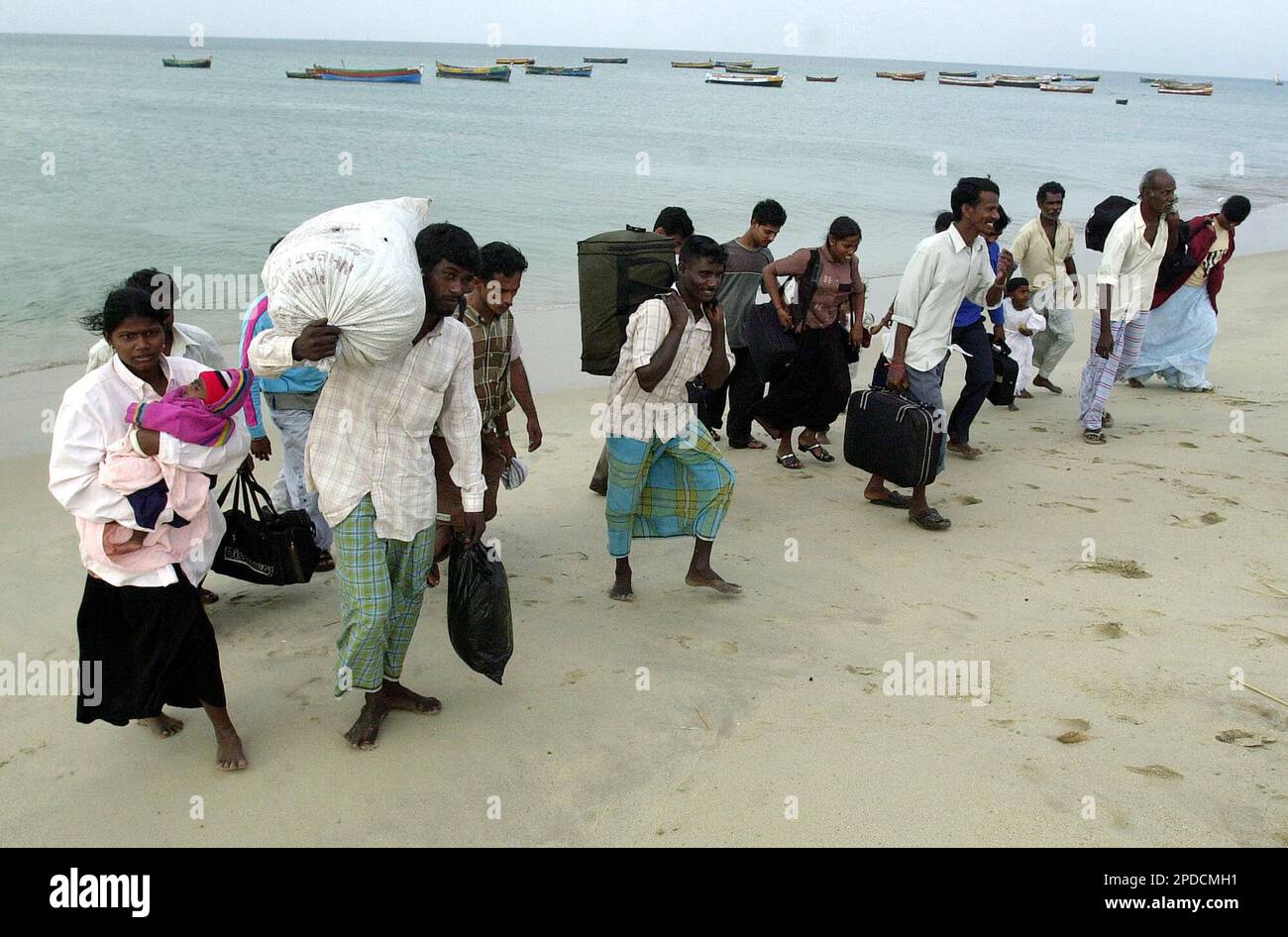 Sri Lankan Tamil Refugees Walk On The Beach After Arriving On Boats At