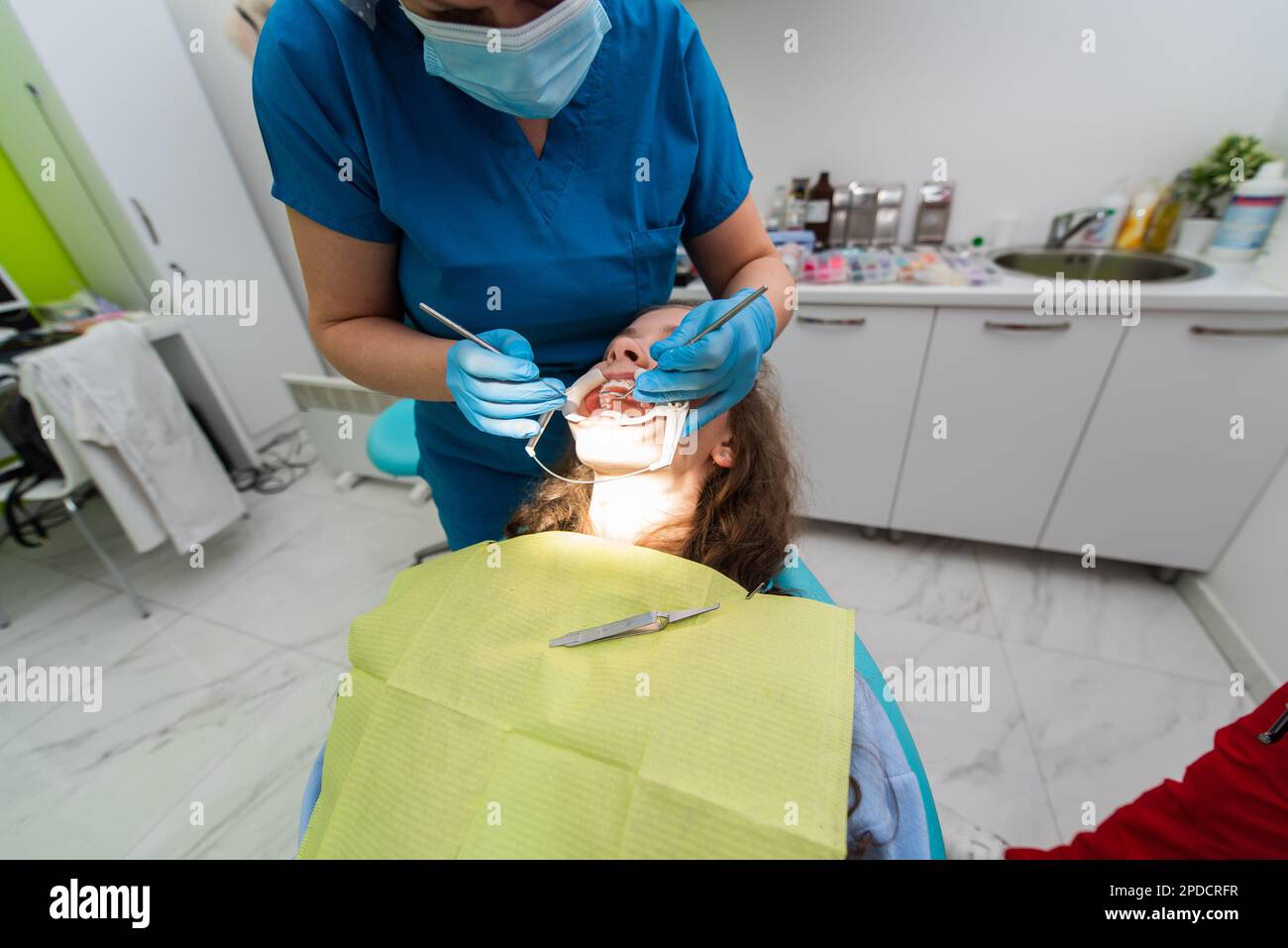 Dentist appointment at a dental clinic, placing braces locks on the