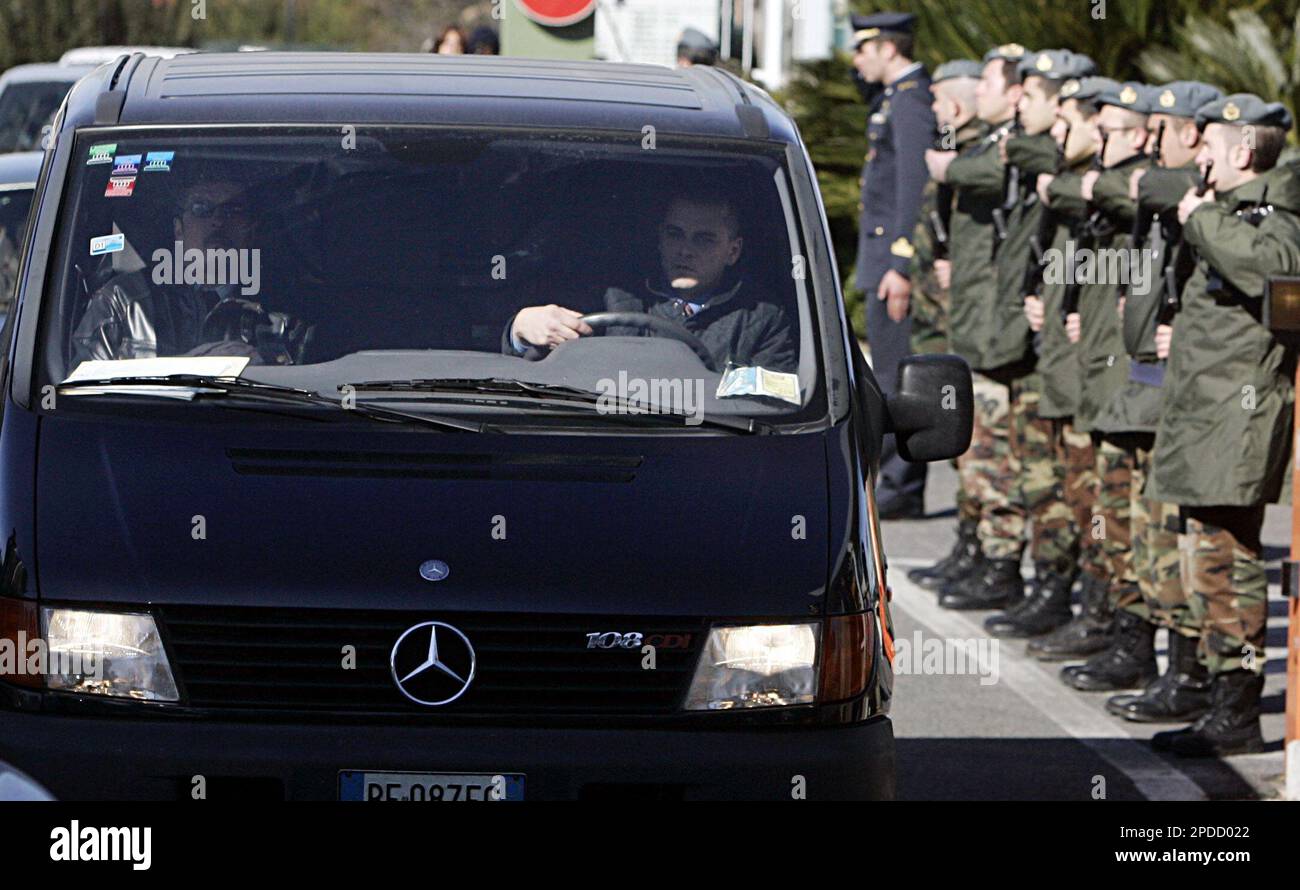 The hearse carrying the coffin of Rev. Angelo Santoro is saluted by
