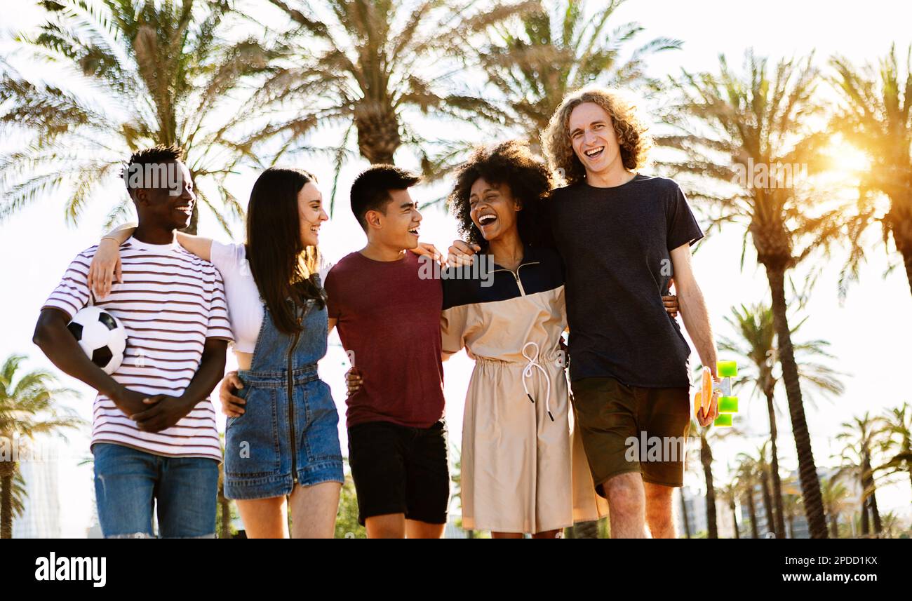 Young group of happy diverse friends laughing while walking together ...