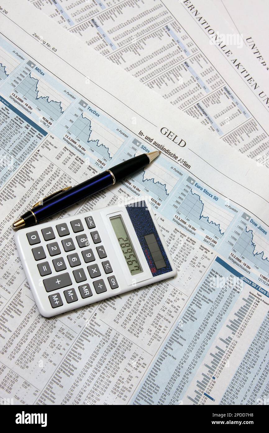 page with stockmarket infos in a newspaper, calculator and ballpen