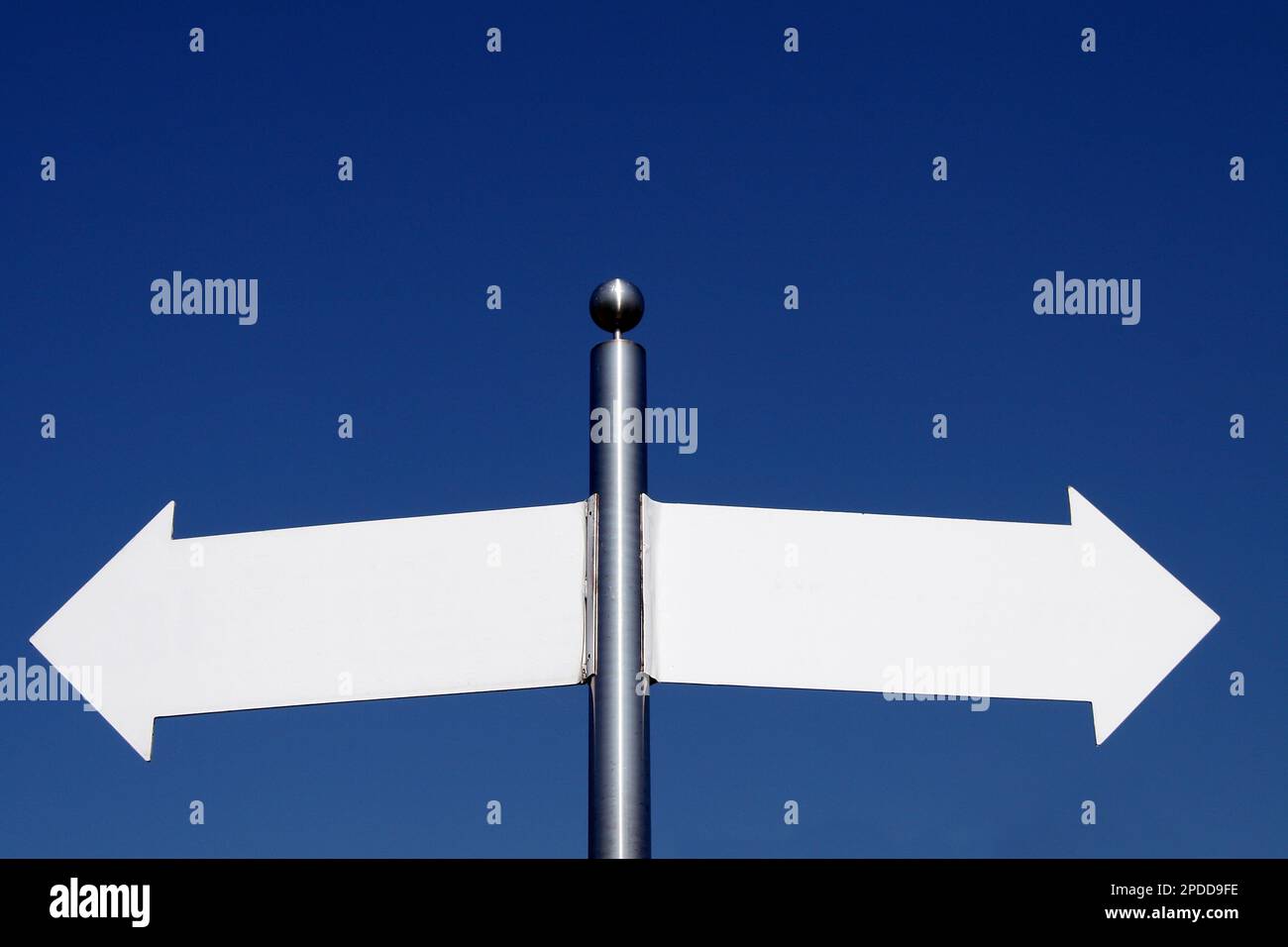 empty signposts pointing in different directions Stock Photo