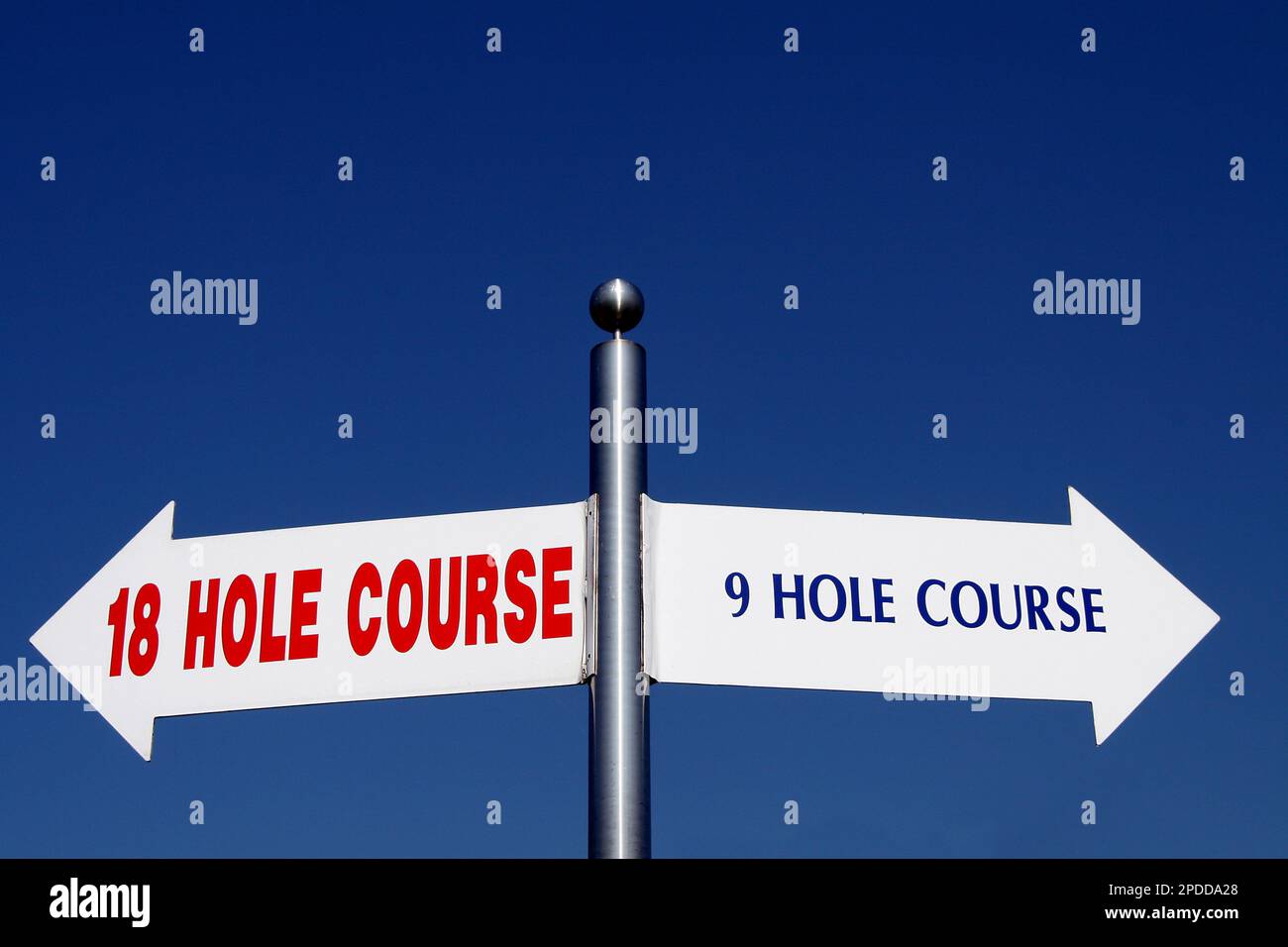 signposts pointing in different directions, options 18 hole course - 9 hole course Stock Photo
