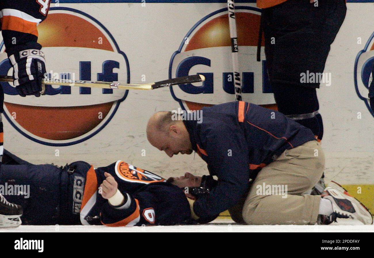 New York Islanders' Kevin Colley, left, pulls the jersey of Vancouver  Canucks' Kevin Bieksa during a fight in the first period, Saturday, January  14, 2006, at Nassau Coliseum in Uniondale, New York. (
