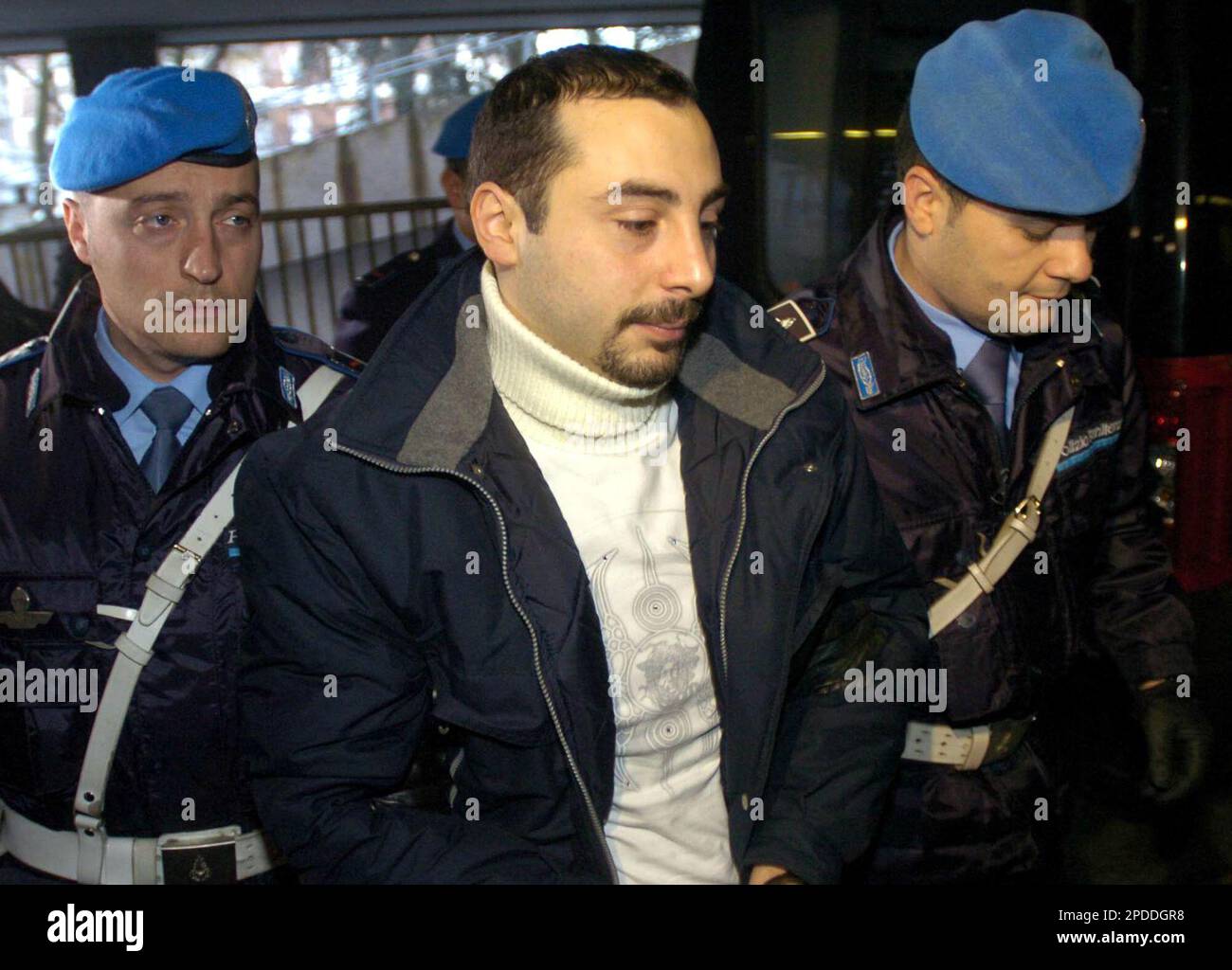 Nicola Sapone is escorted by penitentiary police officers as he enters the  Busto Arsizio court, near Varese, northern Italy, Tuesday, Jan. 31, 2006  for a hearing of the so-called "Bestie di Satana" (
