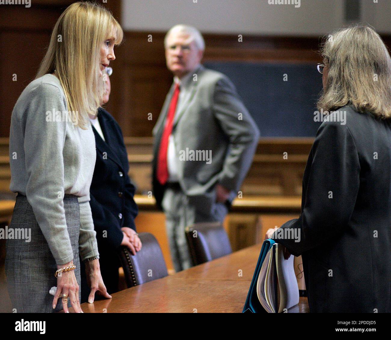 Barbara Asher left confers with defense counsel Jill Sheldon and