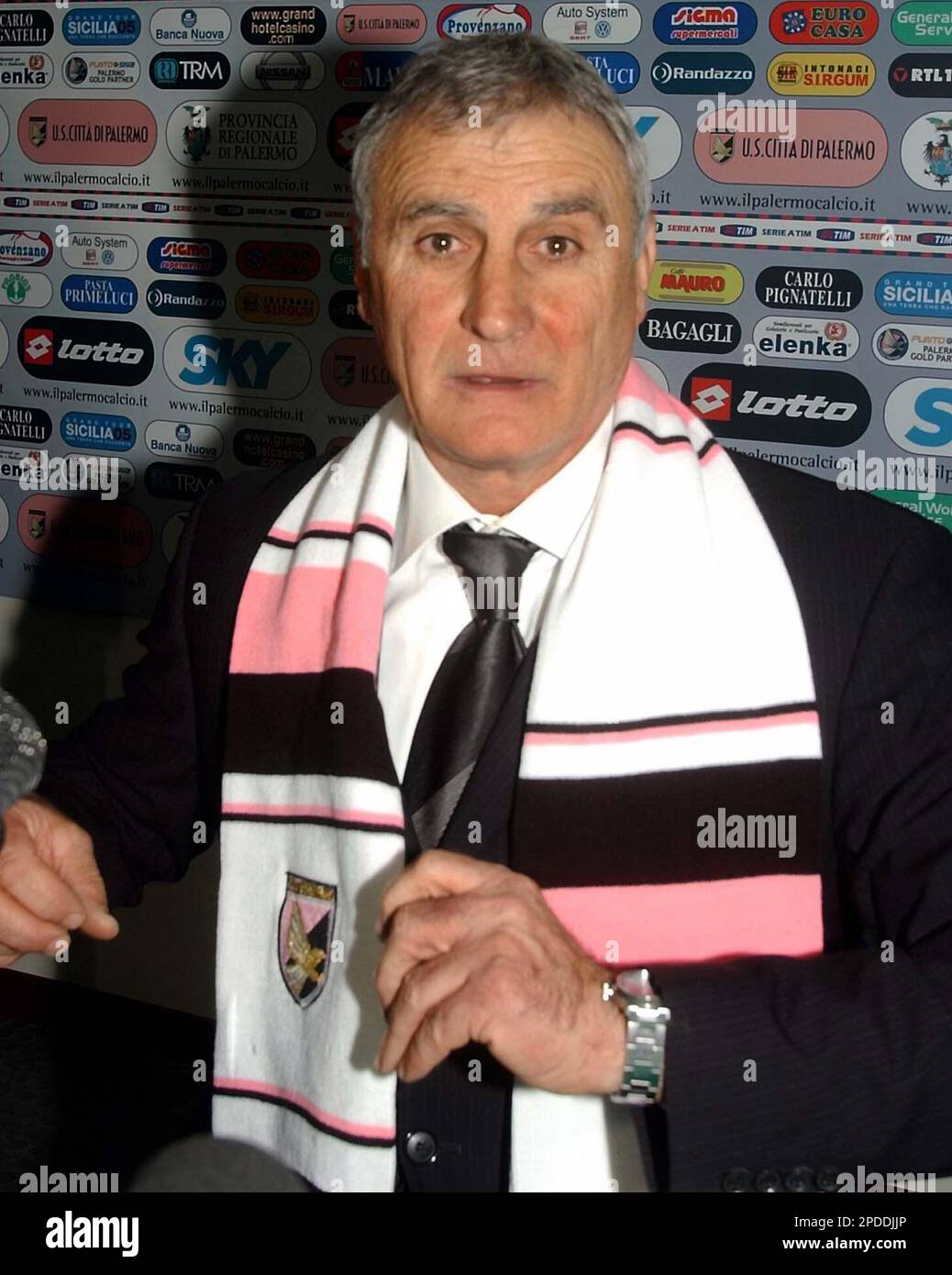 Palermo's new coach Giuseppe Papadopulo wears a soccer scarf during his  presentation in the Palermo soccer team headquarters Monday, Jan. 30, 2006.  Papadopulo was hired to replace Luigi Del Neri as coach