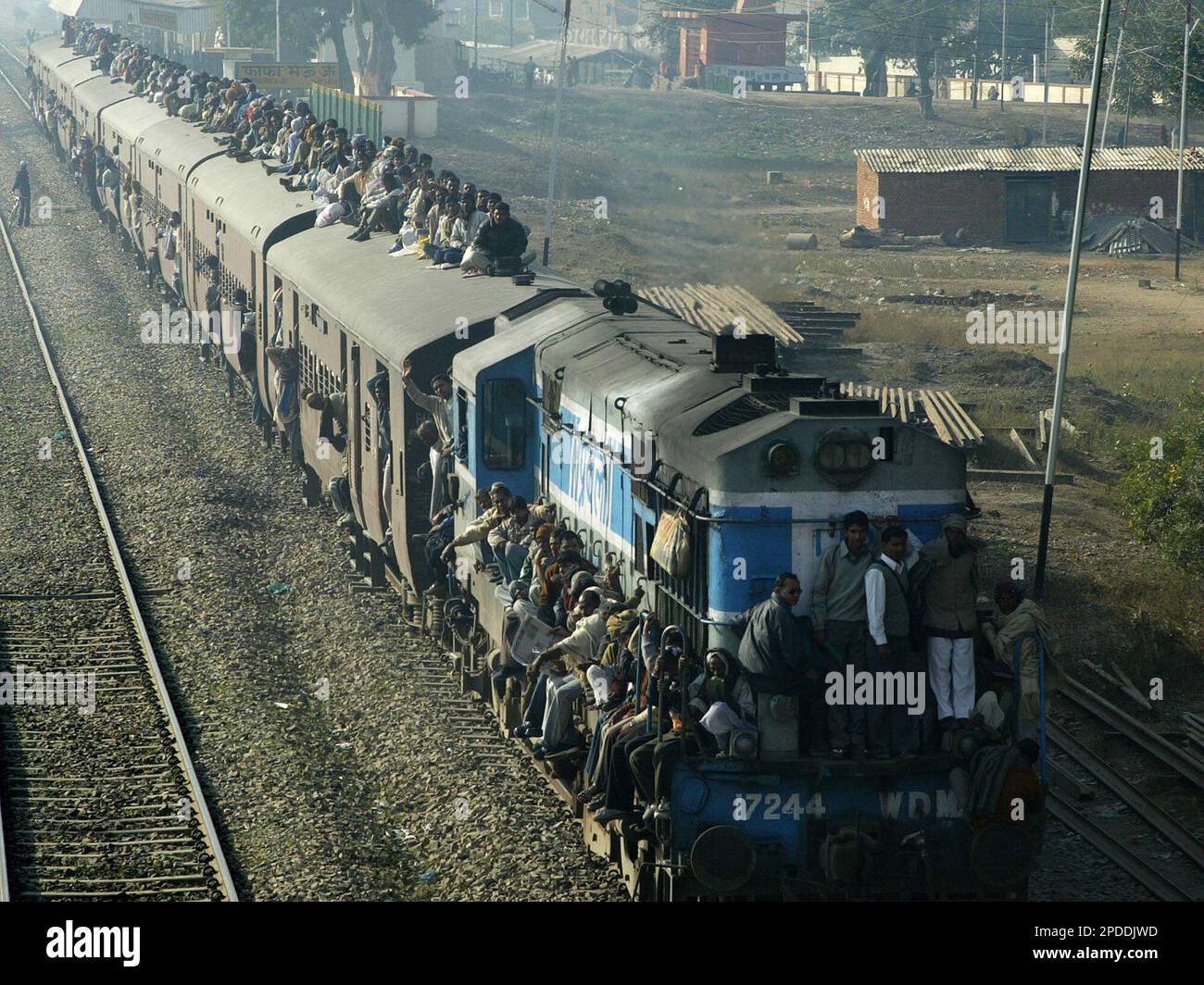 Pilgrims Sit On Top Of A Train As They Leave After Bathing In The River 