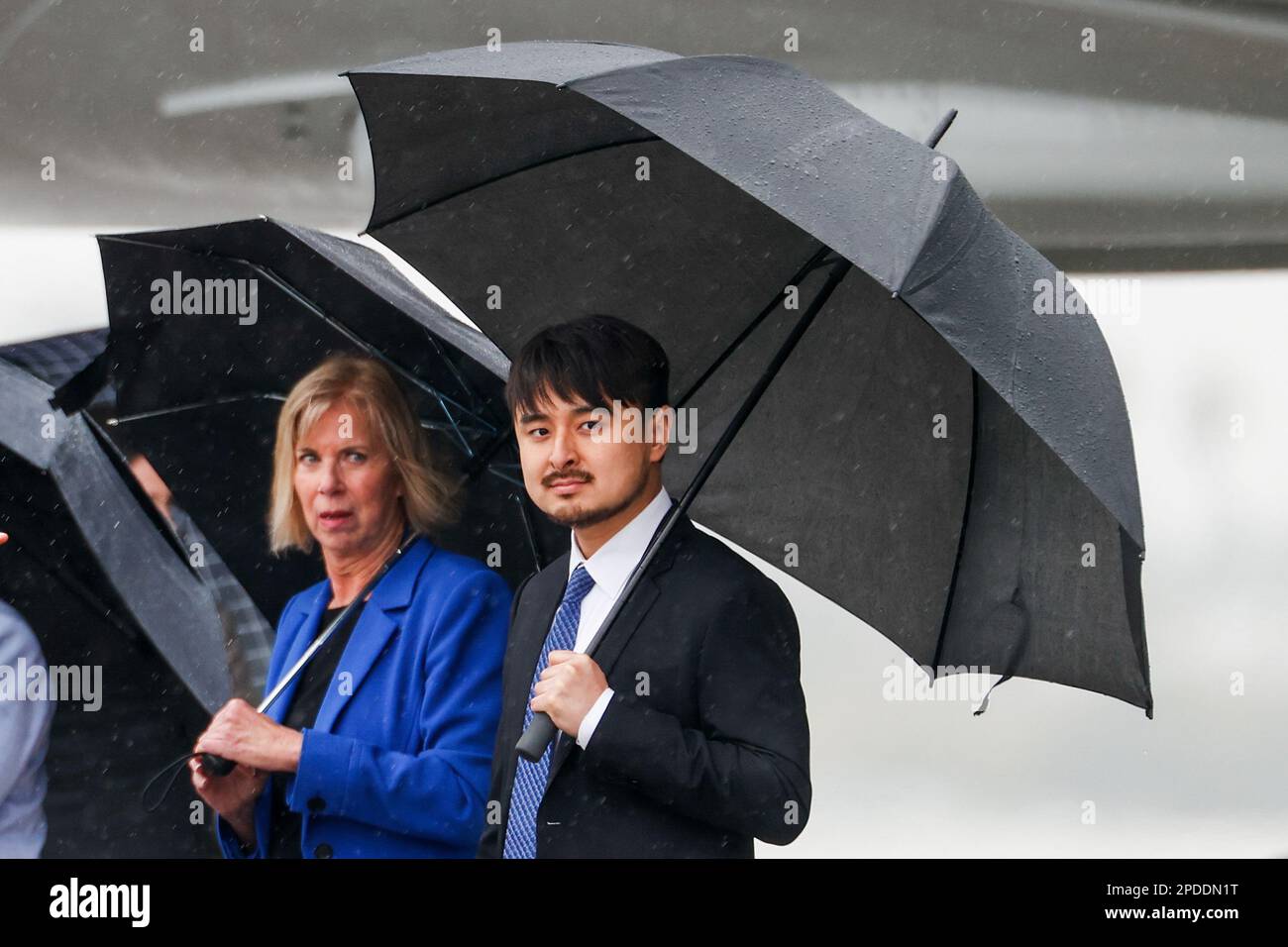 Los Angeles, United States. 14th Mar, 2023. Brandon Tsay (R) and Los Angeles County Supervisor Janice Hahn (L) holding umbrellas wait to welcome President Joe Biden at Los Angeles International Airport. Credit: SOPA Images Limited/Alamy Live News Stock Photo