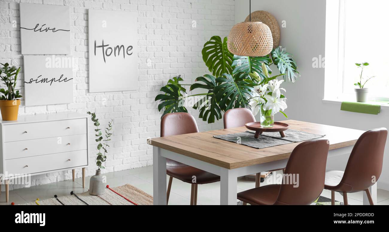 Interior of modern light dining room with big table Stock Photo - Alamy