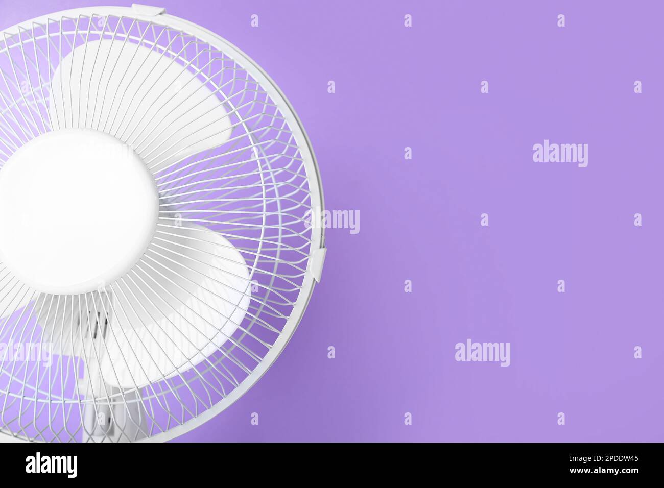 Electric fan on lilac background Stock Photo