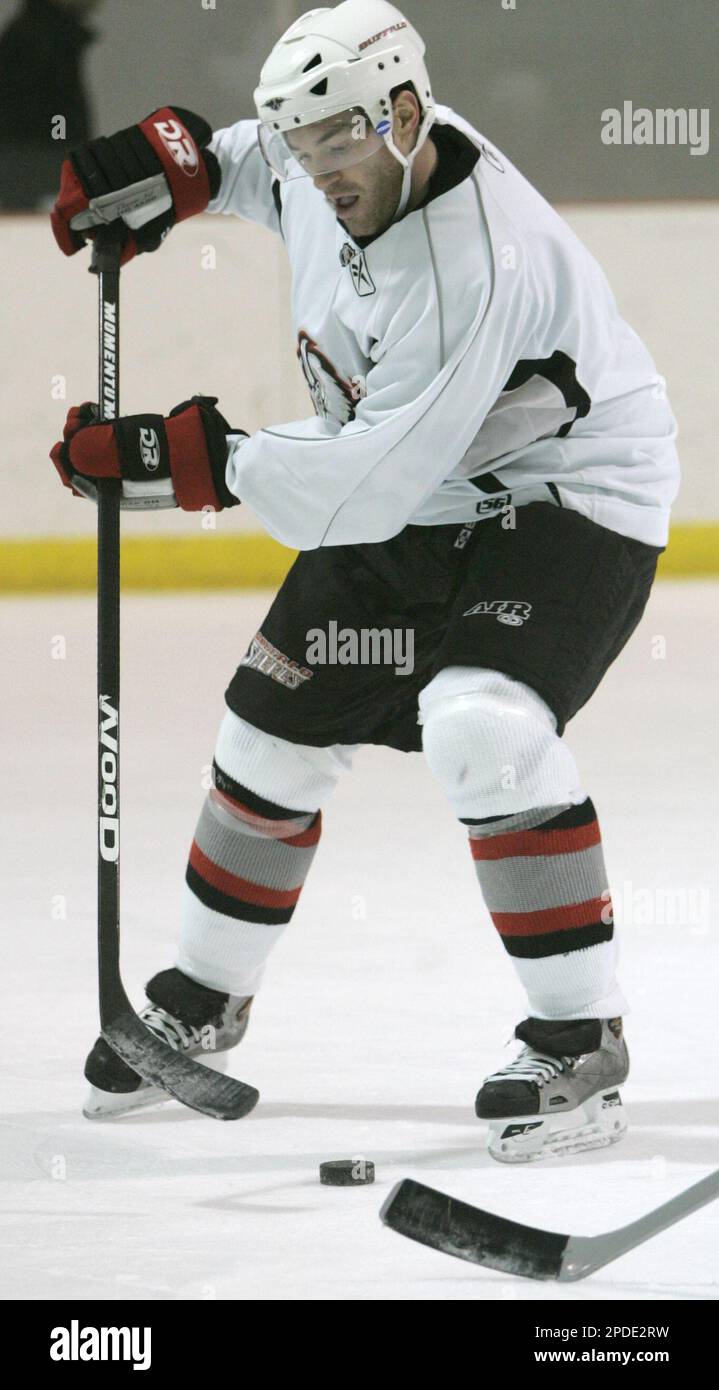 Buffalo Sabres' J. P. Dumont passes between his skates during NHL