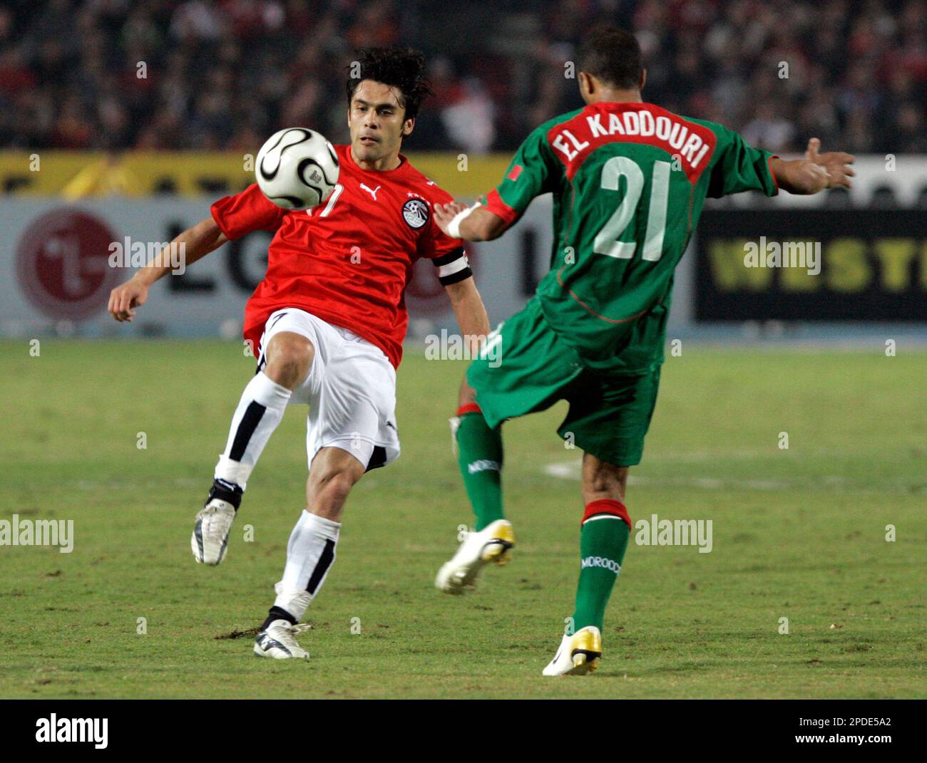 Egypt's Ahmed Hassan takes the ball out of reach of Morocco's Badr