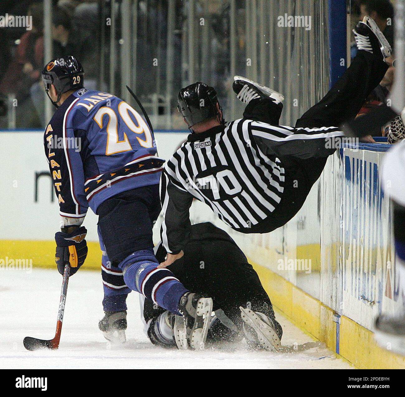Linesman Derek Nelson (70) falls to the ice after colliding with