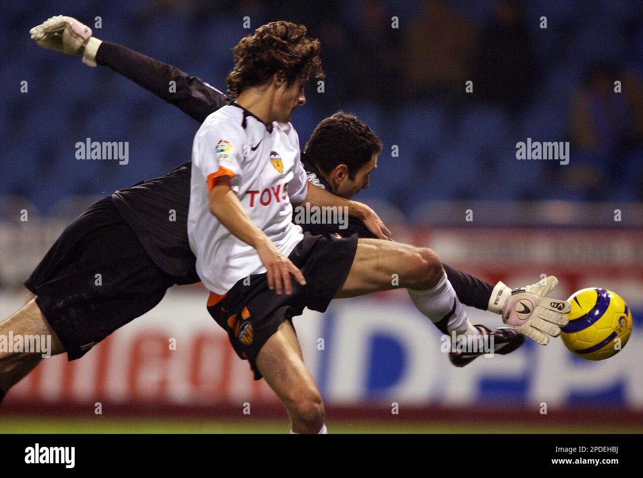 Deportivo's goalkeeper Francisco Molina, left, grabs the ball from  Valencia's Argentinian striker Carlos Aimar during a first-leg soccer match  of the Copa del Rey quarterfinals in La Coruna, Spain, Thursday, Jan. 19,