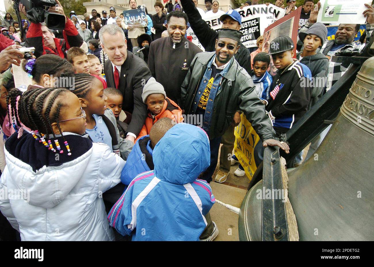 Oklahoma Gov. Brad Henry, center left, helps children ring a replica of the  Liberty Bell as Reginald Mitchell, center, first vice president of the  Oklahoma City NAACP, and Roosevelt Milton, center right,